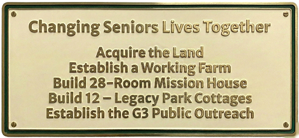 an emamel plaque detailing the elements of building a village